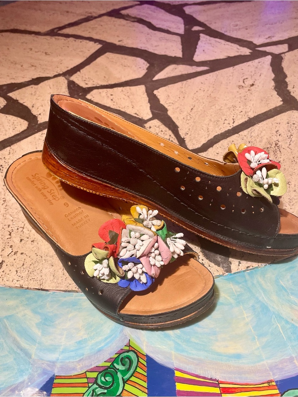 Women's Black Leather Spring Step Slip-On Sandals with Multicolor Floral Accent